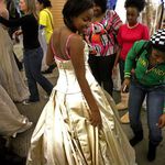 Karena Knight tries on a dress as her sister inspect it.